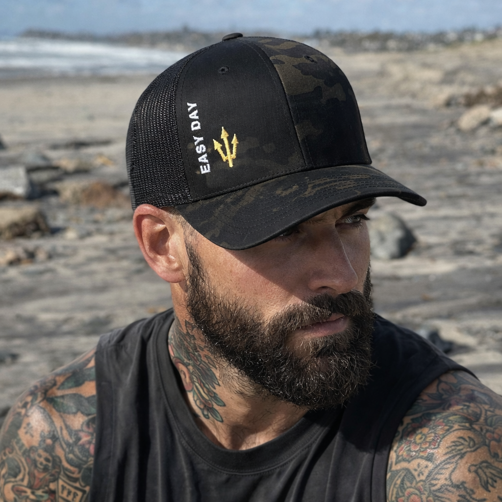 Man wearing a black cap with 'Easy Day' logo outdoors