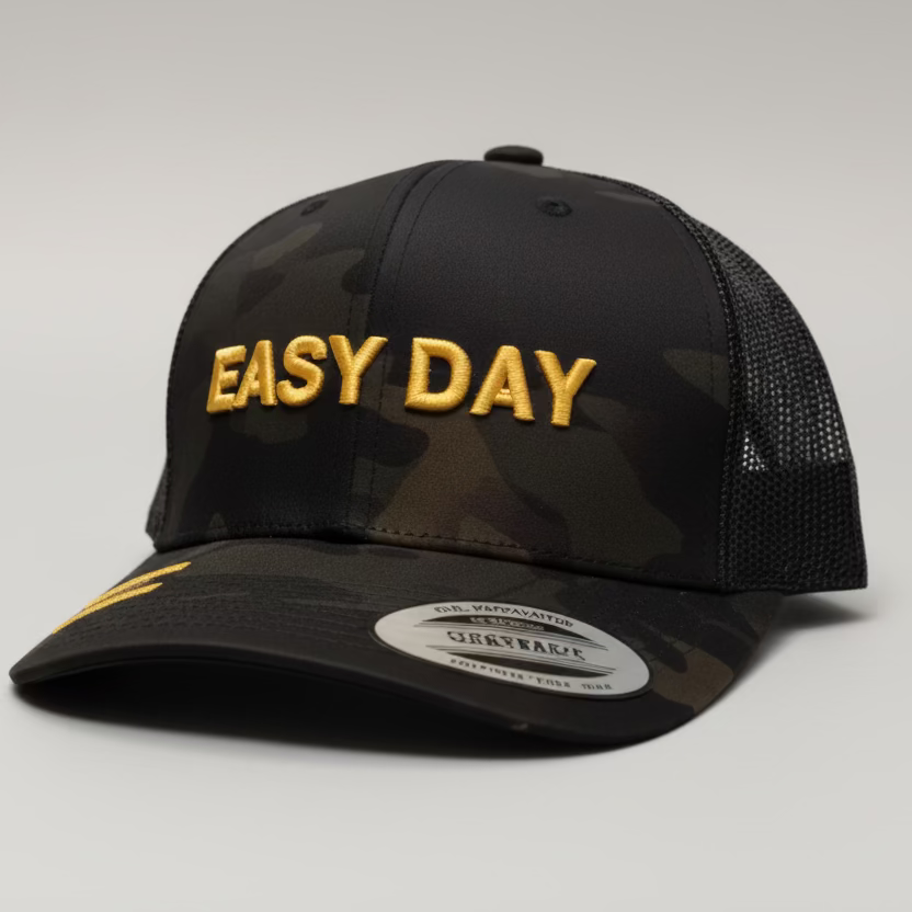 Two black caps with 'Easy DAY' text on a white surface in a room.
