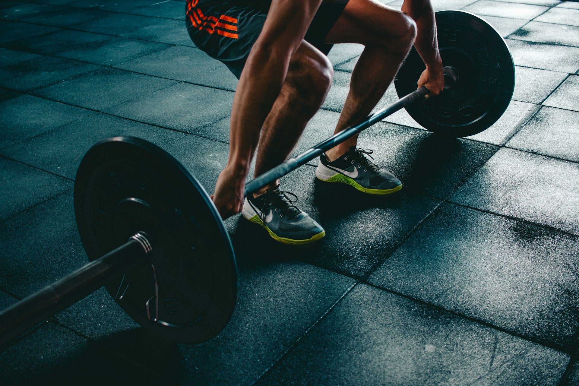 Gym floor and dumbbells — training that carries into the day (Unsplash)