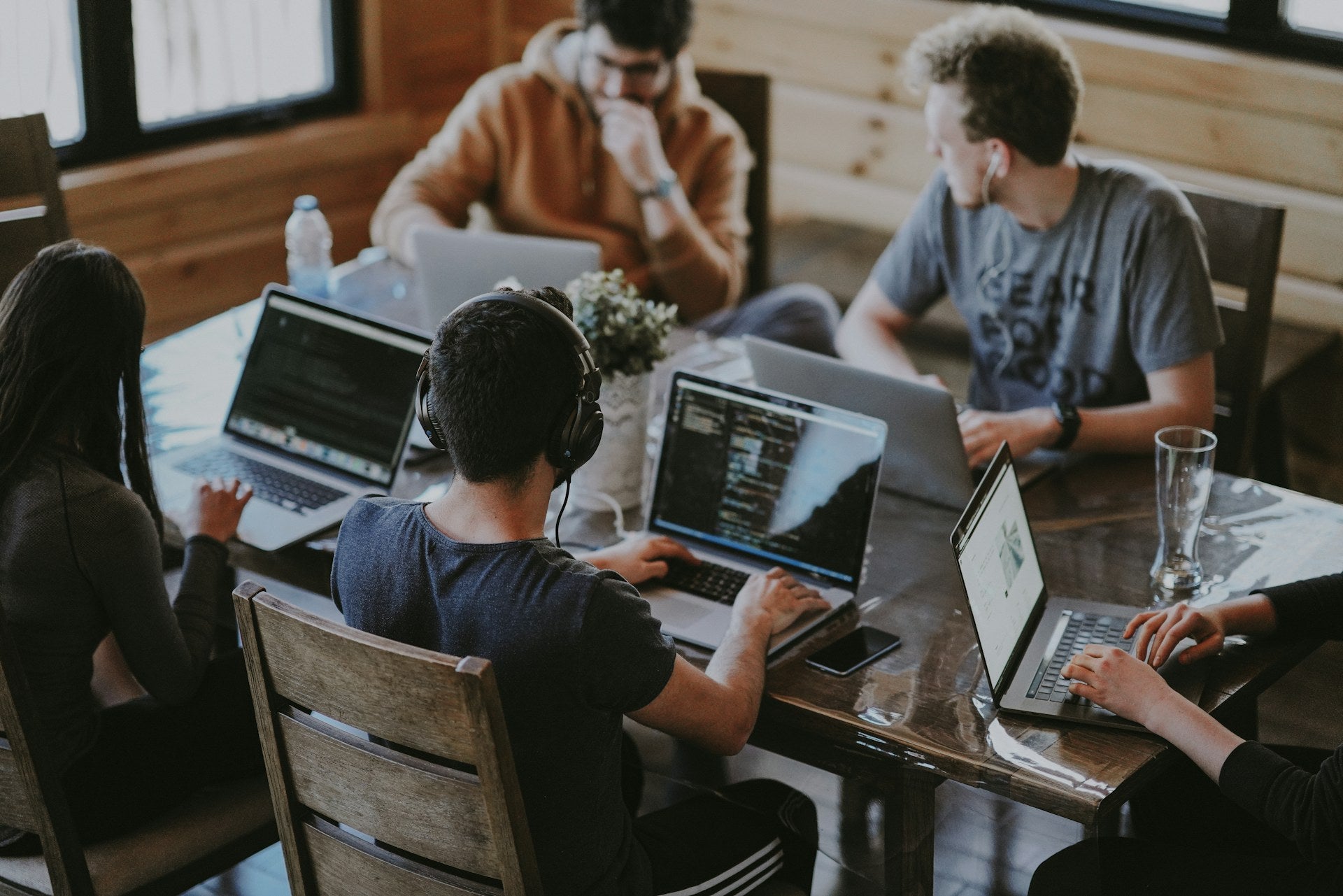 Team collaboration at a table — small-unit clarity (Unsplash)