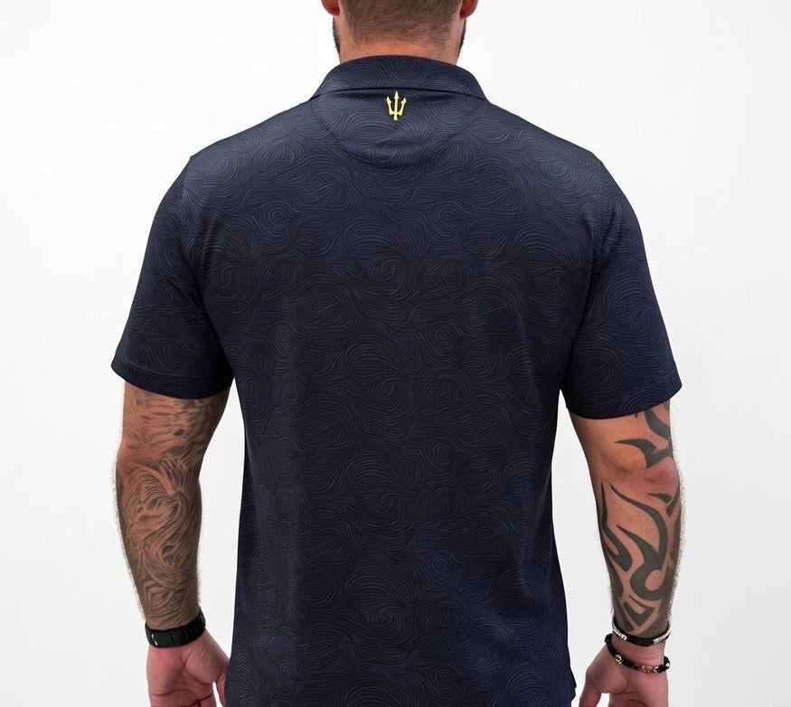 Man wearing a navy blue polo shirt with a logo on the collar against a white background