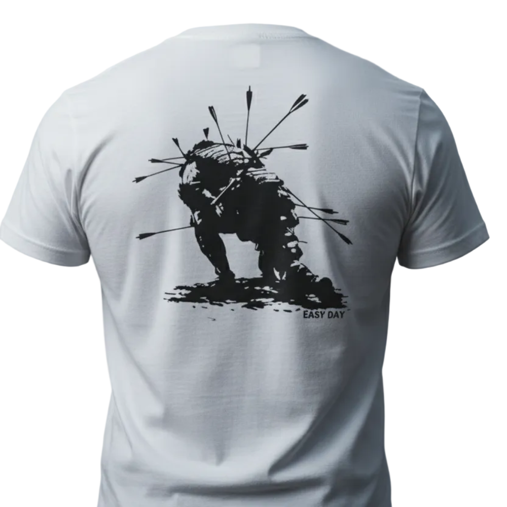 Man wearing a white t-shirt with a black graphic design on the beach