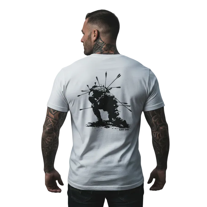 Man wearing a white t-shirt with a black graphic design on the beach