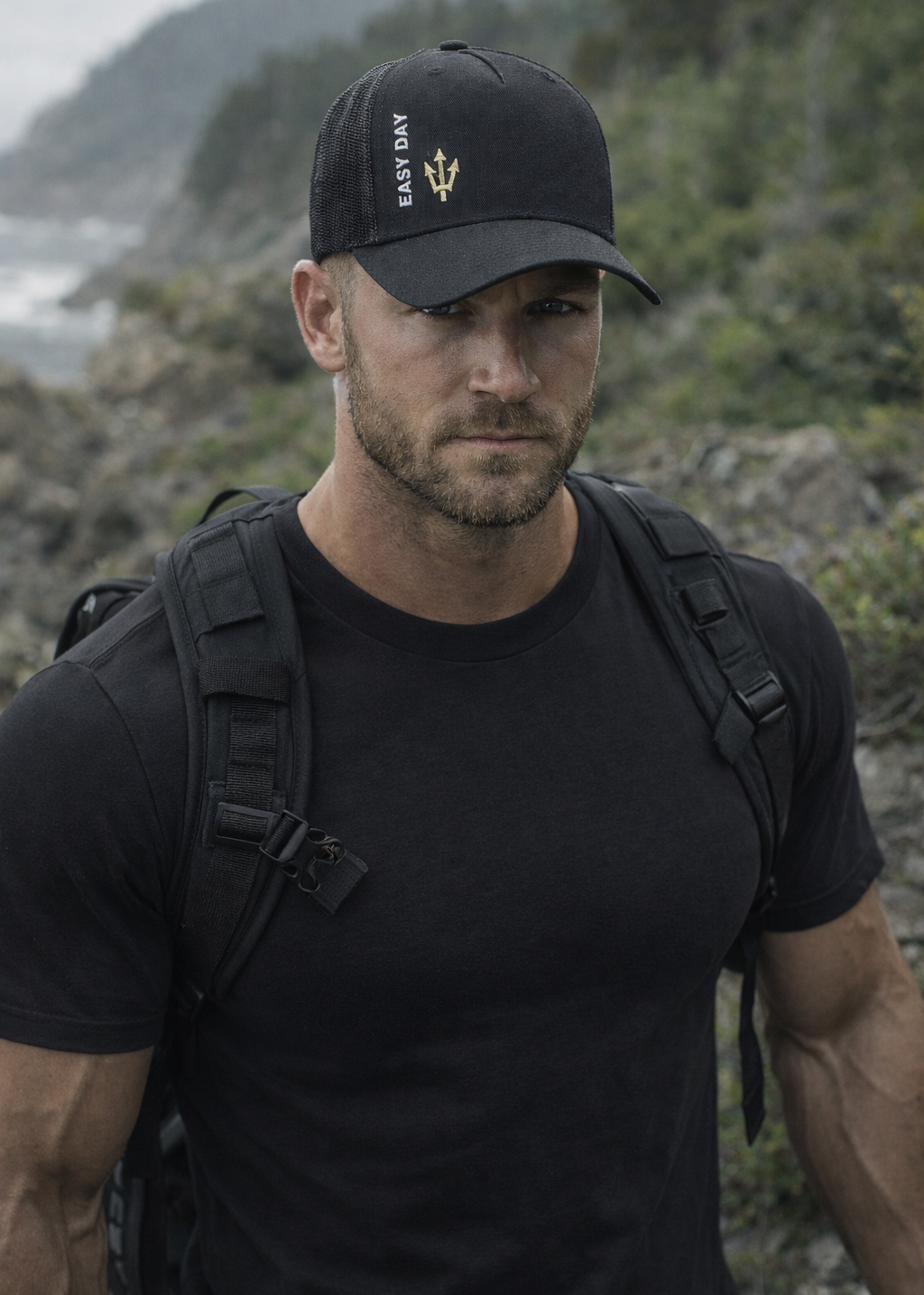 Man wearing a black cap and backpack in a mountainous area